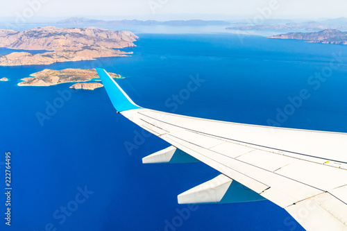 Aerial view of sea and greek islands with airplane wing