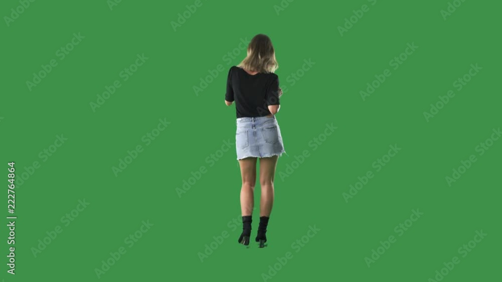Back view of young sexy happy woman dancing isolated on green screen background Back view of young sexy happy woman dancing isolated on green screen background