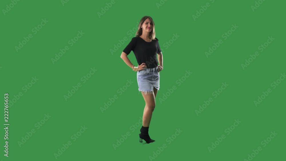 Stylish modern young beautiful woman posing from side turns to camera isolated on green screen background Stylish modern young beautiful woman posing from side turns to camera isolated on green screen background