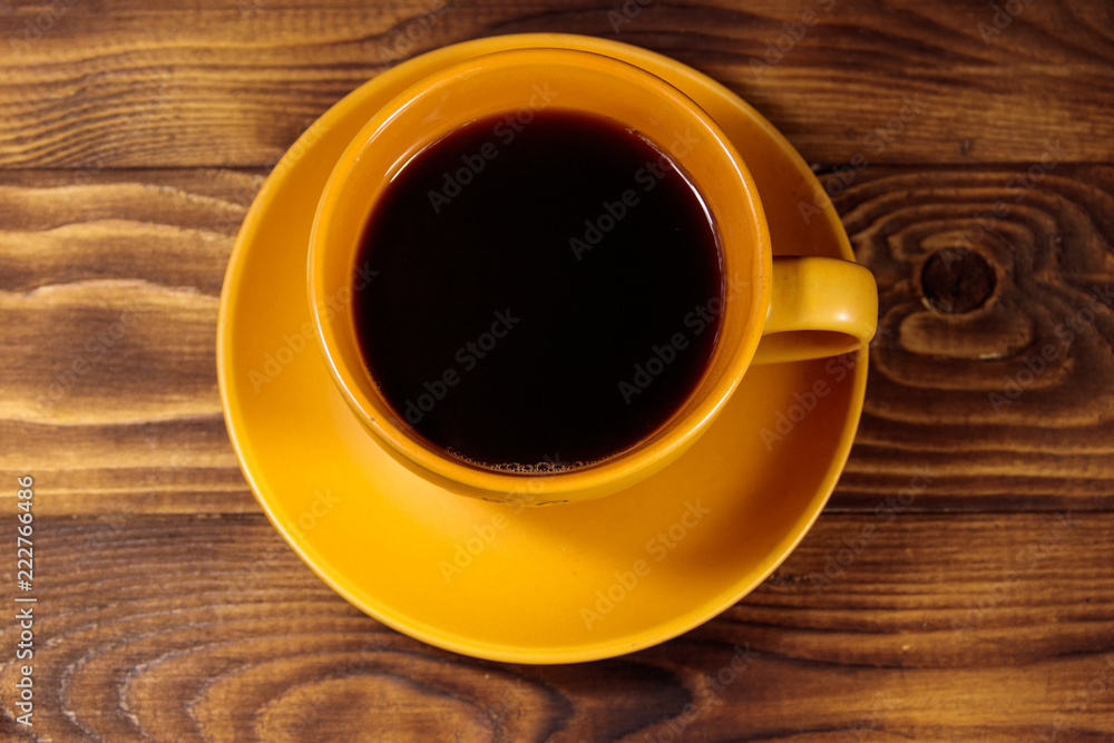 Cup of coffee on the wooden table. Top view Cup of coffee on the wooden table. Top view