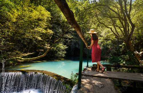 Girl enjoying day outdoors at a natural water well photo