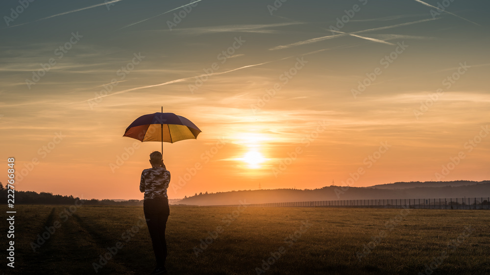 silhouette of woman with an umbrella