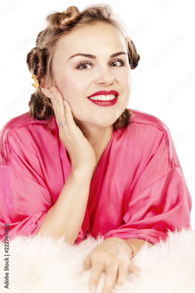 Young beautiful woman in curlers on head smiling, isolated on white background Young beautiful woman in curlers on head smiling, isolated on white background