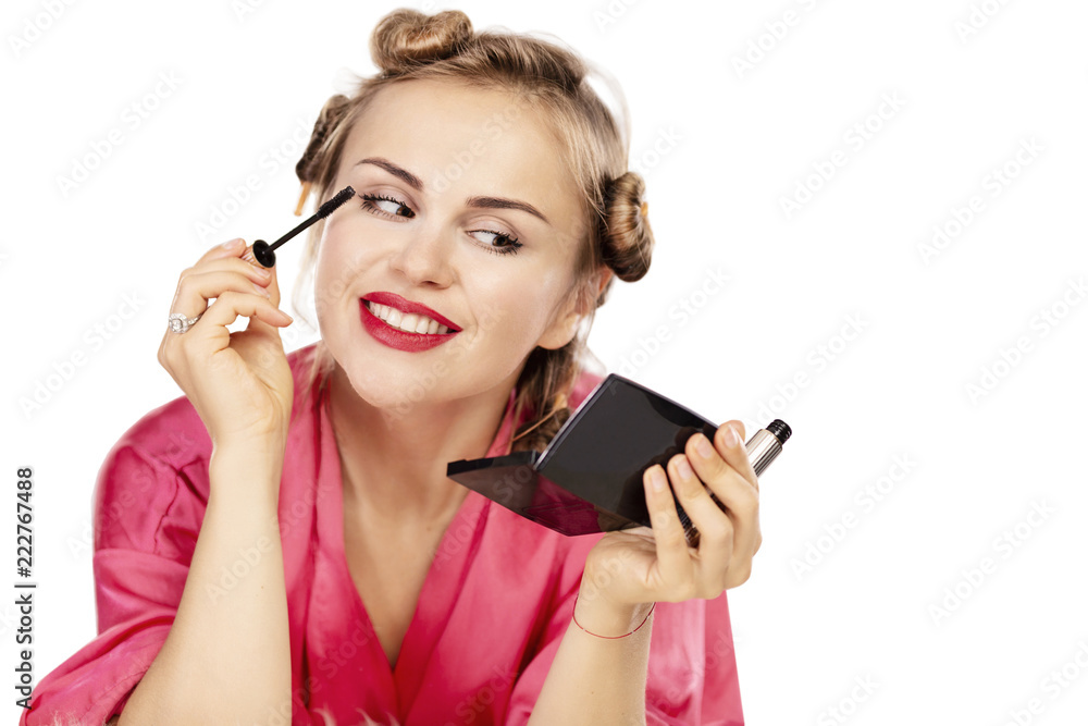Young beautiful woman in curlers smiling, isolated on white background Young beautiful woman in curlers smiling, isolated on white background