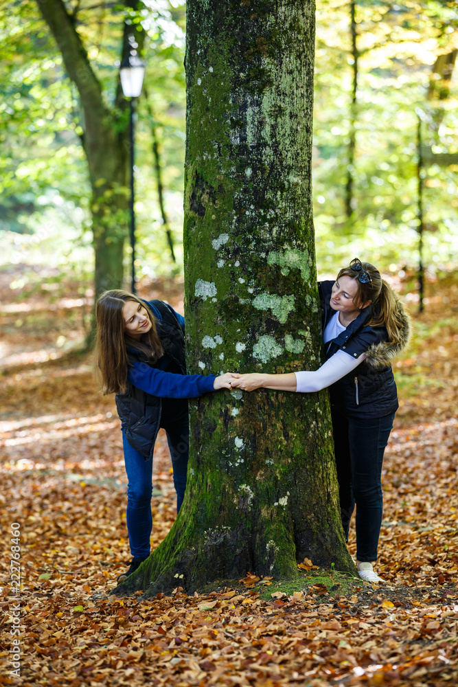 Women hugging tree Women hugging tree
