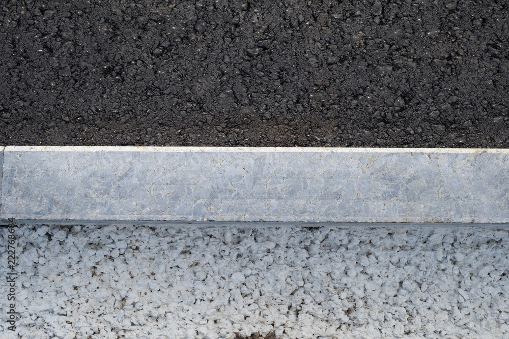 Fototapeta premium New asphalt road, curbs and of gravel and concrete.
