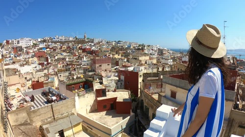 Woman looks at the famous tanger medina from a wonderful terrace
