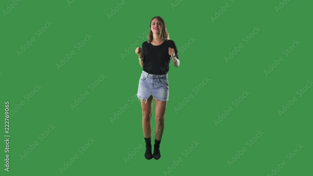 Young happy woman dancing and celebrating success isolated on green screen background Young happy woman dancing and celebrating success isolated on green screen background