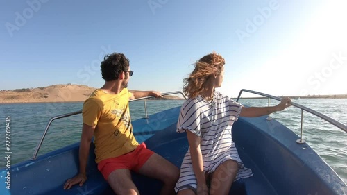 Adventurous tourists couple travel by boat to an amazing deserted beach
