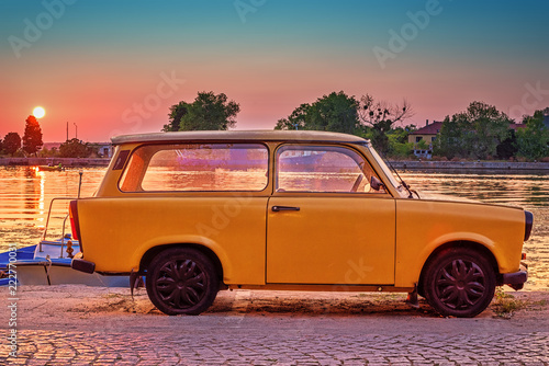 фотография Vintage yellow car on sunset