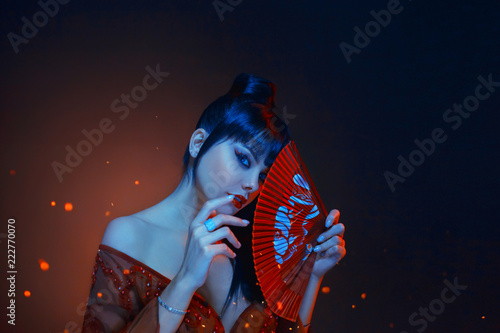Fotografie, Obraz a beautiful geisha with blue long hair and a bang is looking in soul