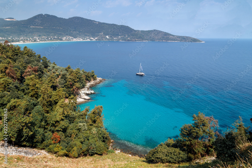 Thassos island, Greece. View to the coastline made of hills, cliffs, Mediterranean scrub, pine trees, and blue sea. Travel Europe, holidays in Greece.