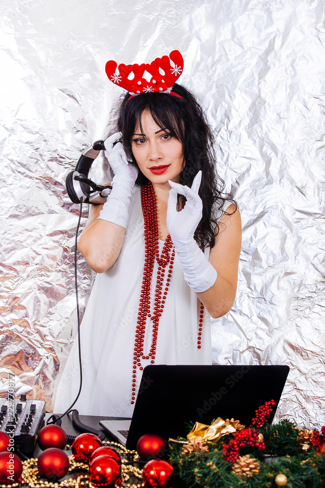 DJ woman New Year Santa costume headphones silver background party girl red  horns christmas decorations brunette white dress Stock Photo | Adobe Stock