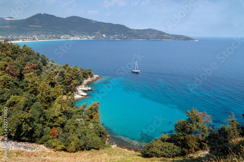 Thassos island, Greece. View to the coastline made of hills, cliffs, Mediterranean scrub, pine trees, and blue sea. Travel Europe, holidays in Greece.