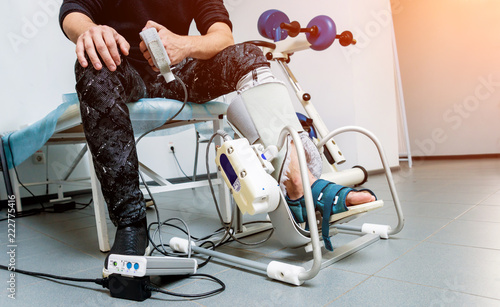 Patient on CPM (continuous passive range of motion) machines. Device to provide anatomically correct motion to both the ankle and subtalar joints. photo