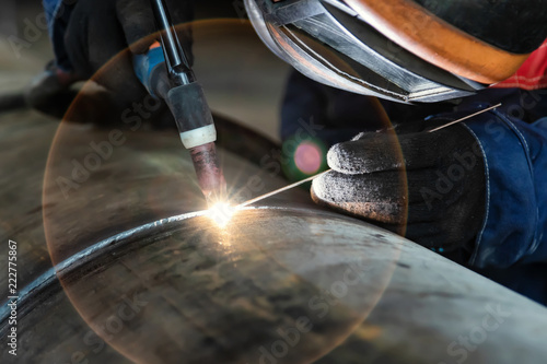 Assembly of pipeline assemblies in the Assembly shop using argon-arc welding. Welder, arc welding and weld seam close-up photo