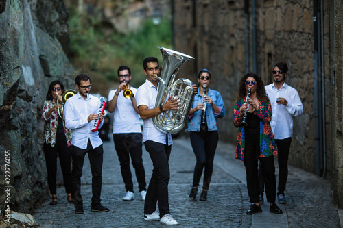 Sticker Jazz band a group of musicians with wind instruments playing on the street of the city