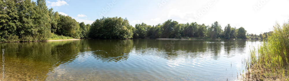 lake in germany with trees and reflection in water