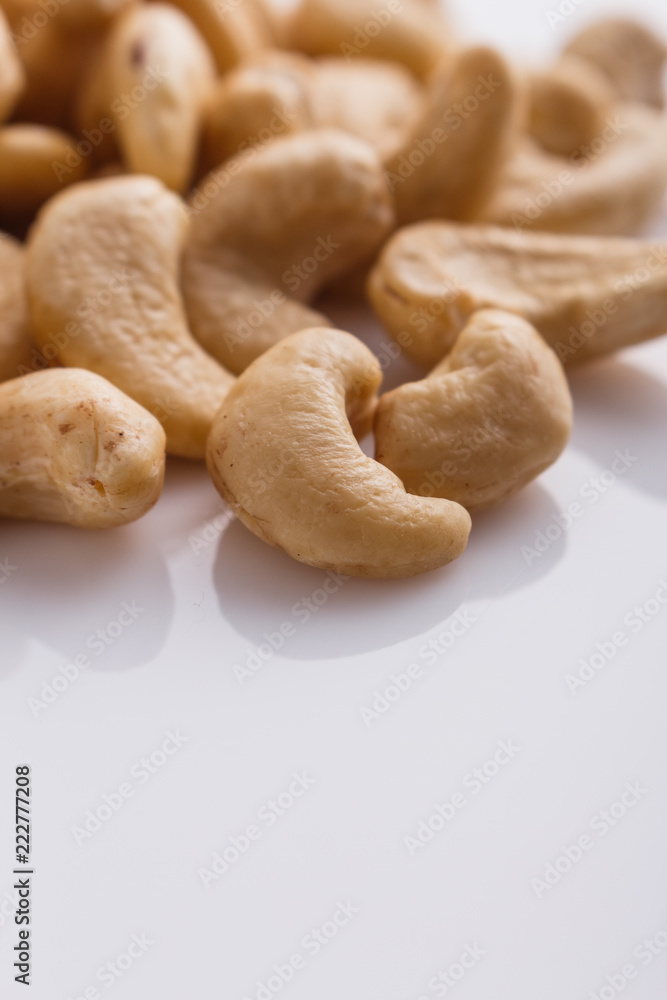 Fototapeta premium cashew nuts on a white acrylic background