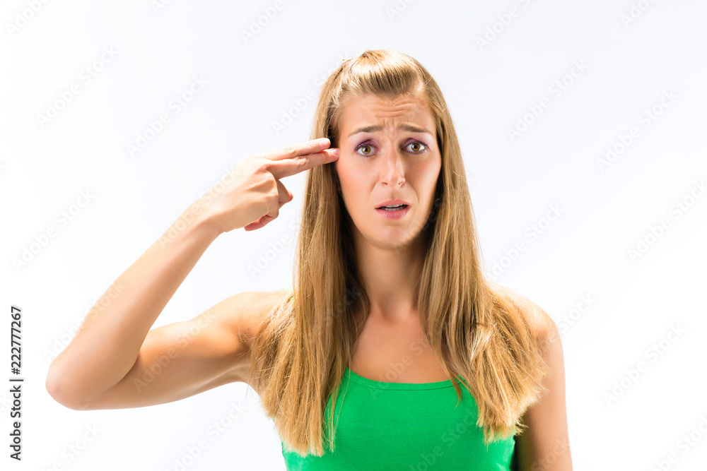 Portrait of exhausted young woman makes suicide gesture isolated over white background Portrait of exhausted young woman makes suicide gesture isolated over white background