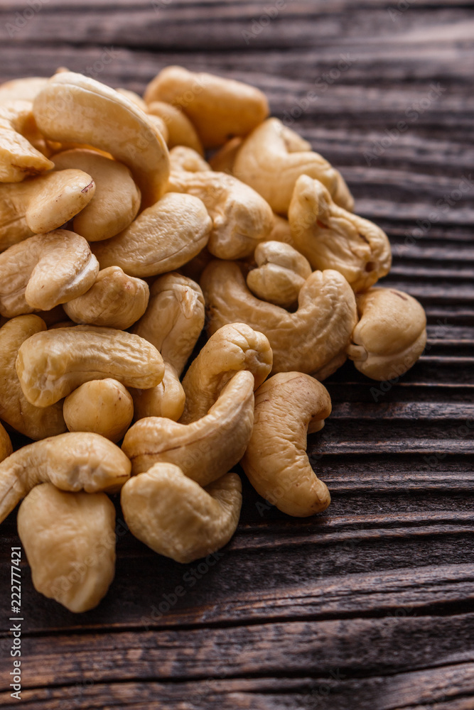 Fototapeta premium cashew nuts on a rustic wooden background