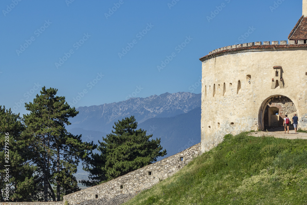 the walls of the Rasnov castle with the Carpathians in the background in Romania