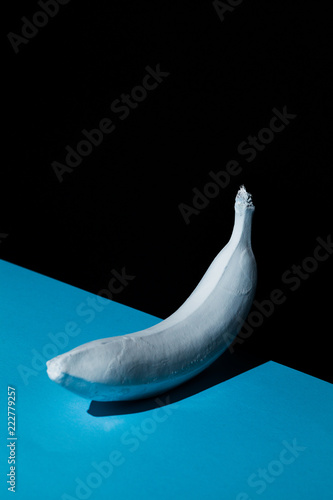 White banana on blue and black background