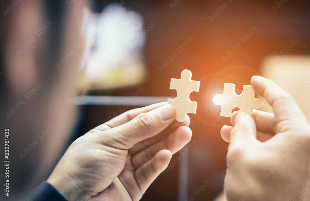 Business People hands trying to connect couple puzzle piece .one part ...