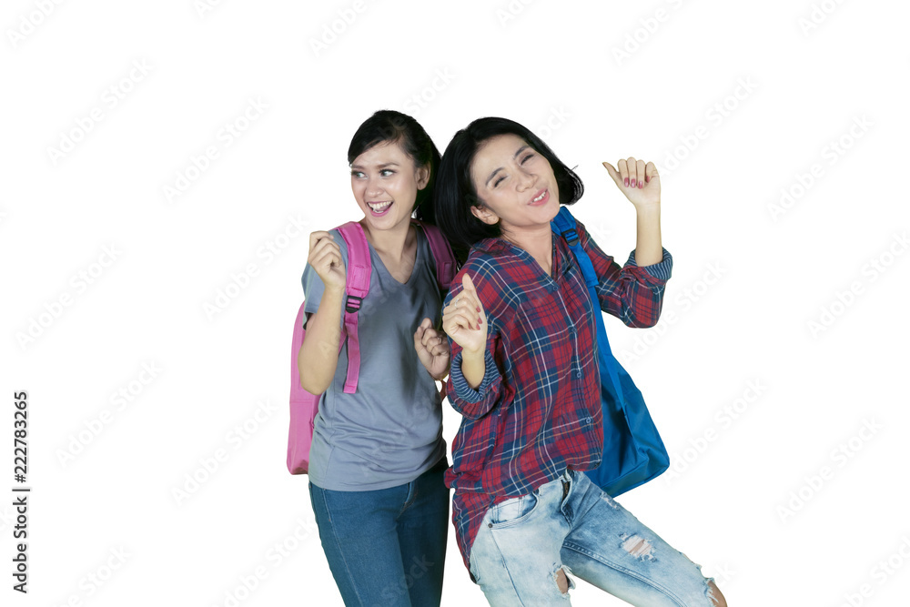 Fototapeta premium Cheerful female students dancing together