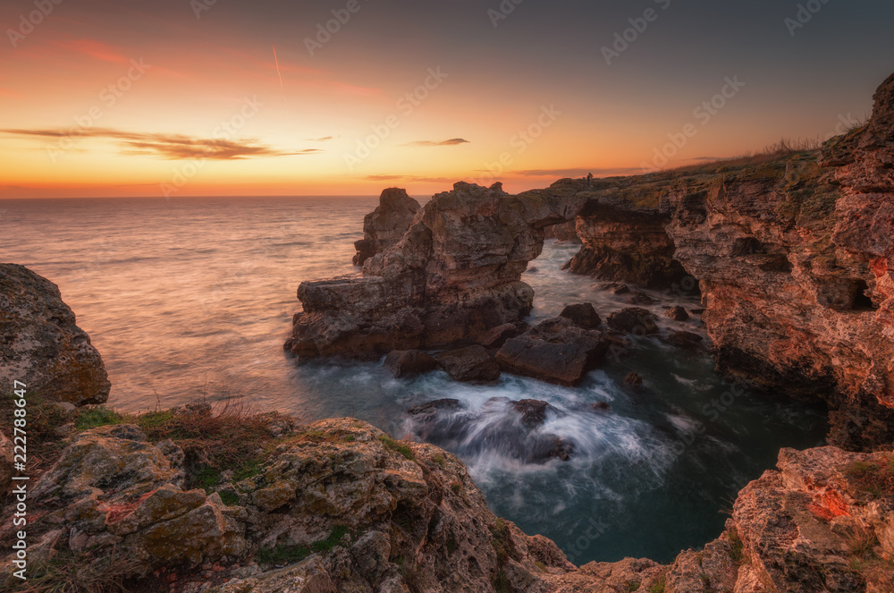 Seascape during sunrise. Beautiful natural seascape. Sea sunrise at the village of Tyulenovo. Magnificent sunrise with clouds and fire sun in the middle of December. Varna, Bulgaria