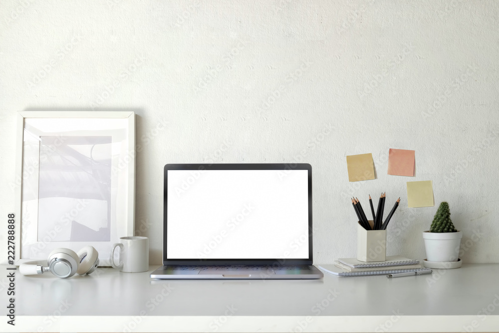 Mockup poster empty frame with blank screen laptop on workspace table
