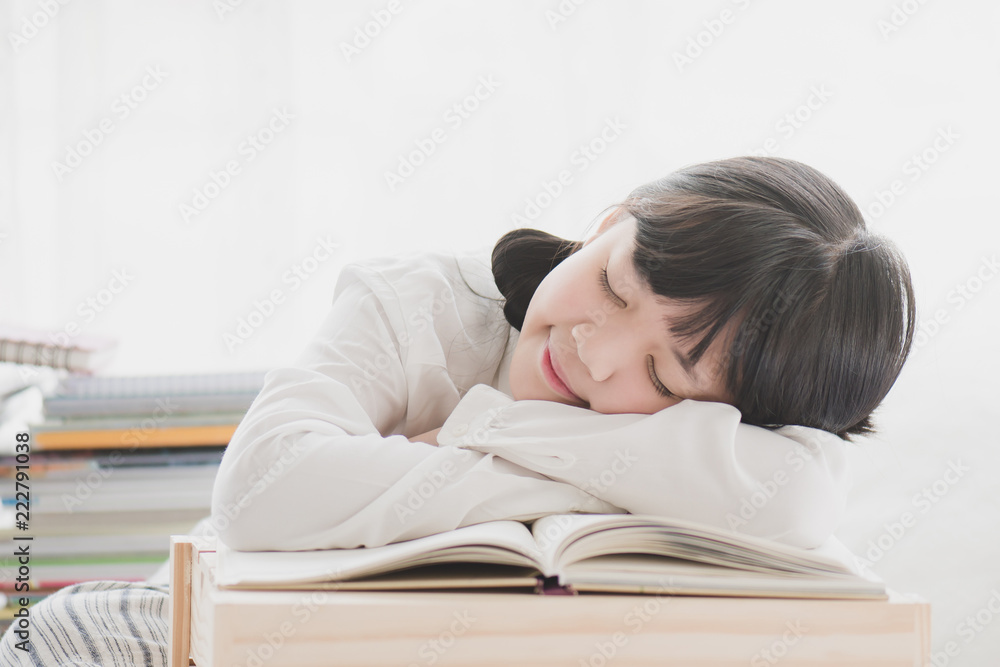 Beautiful Asian girl sleeping on the books Beautiful Asian girl sleeping on the books