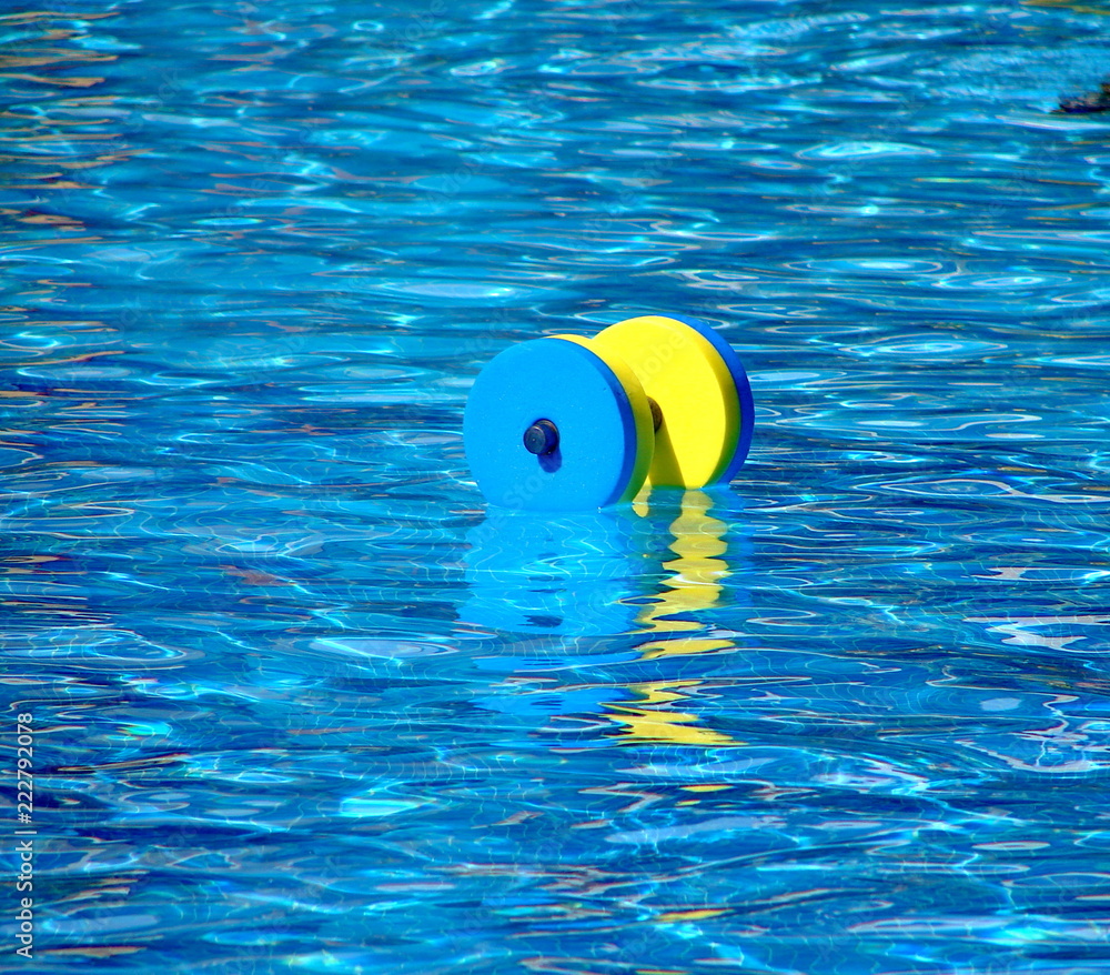 Floating aqua aerobics dumbbell in a pool