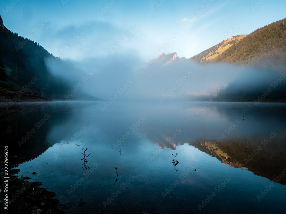 fog covered mountain lake during sunrise morning switzerland