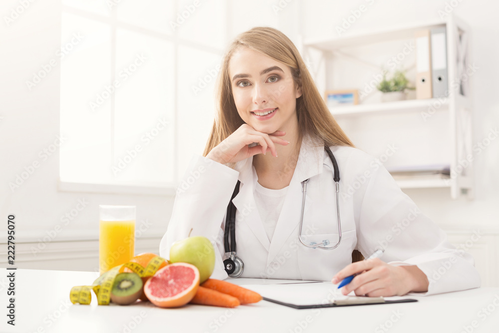 Nutritionist desk with fruit and measuring tape Nutritionist desk with fruit and measuring tape