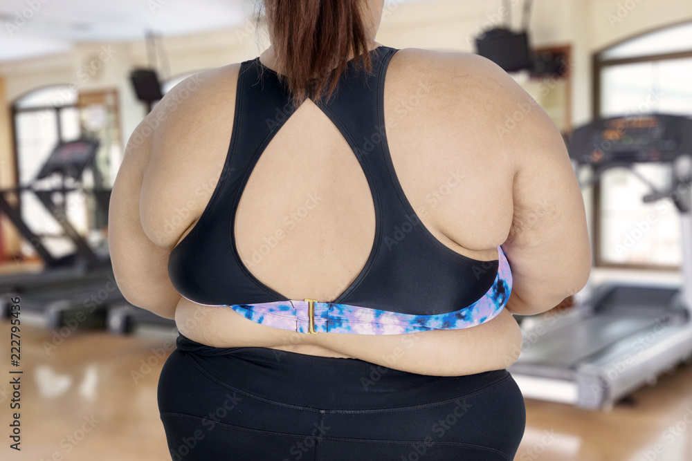 Young woman standing with her fat body Young woman standing with her fat body