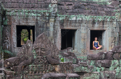 Girl looking at Angkor Wat temple in Cambodia
