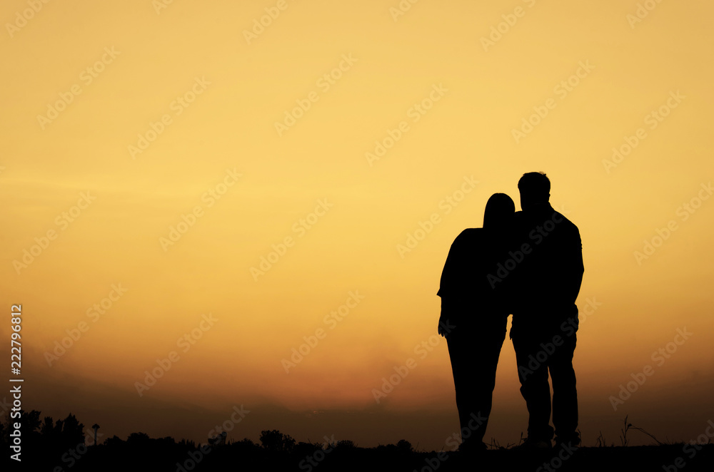 Silhouette of sweet couple in love happy time in beautiful sunset