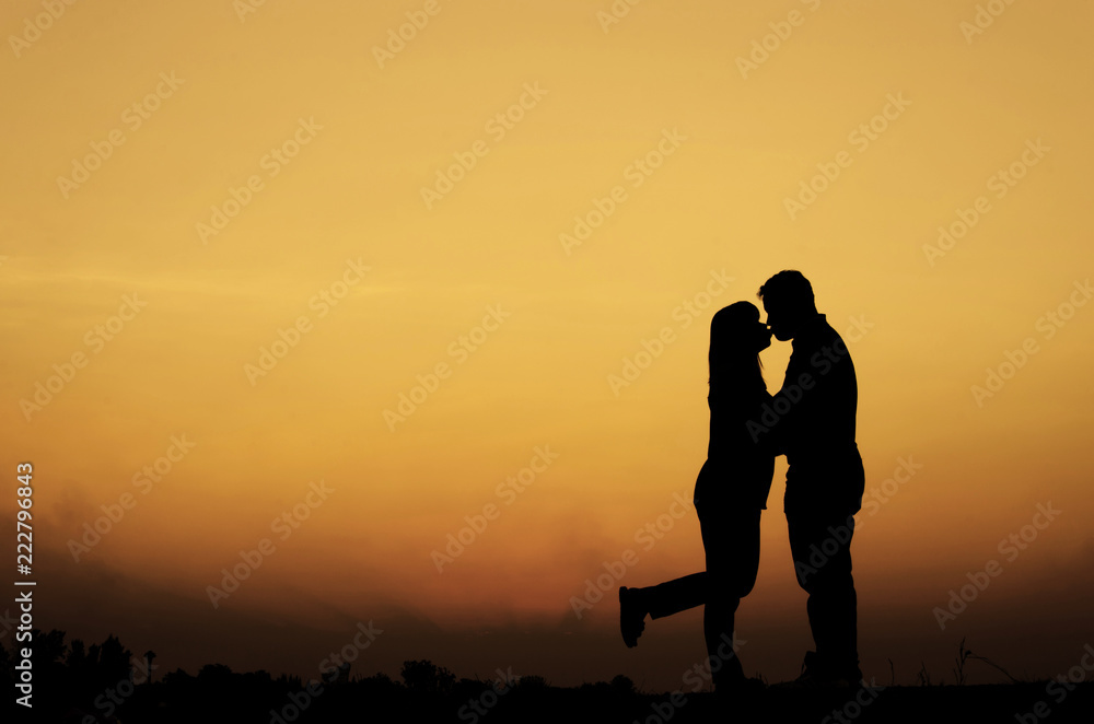 Silhouette of sweet couple in love happy time in beautiful sunset