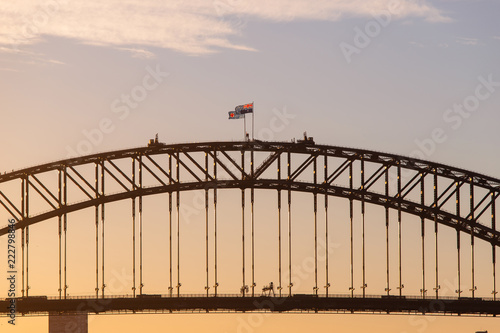 Sydney Harbour Bridge with warm sunset sky.