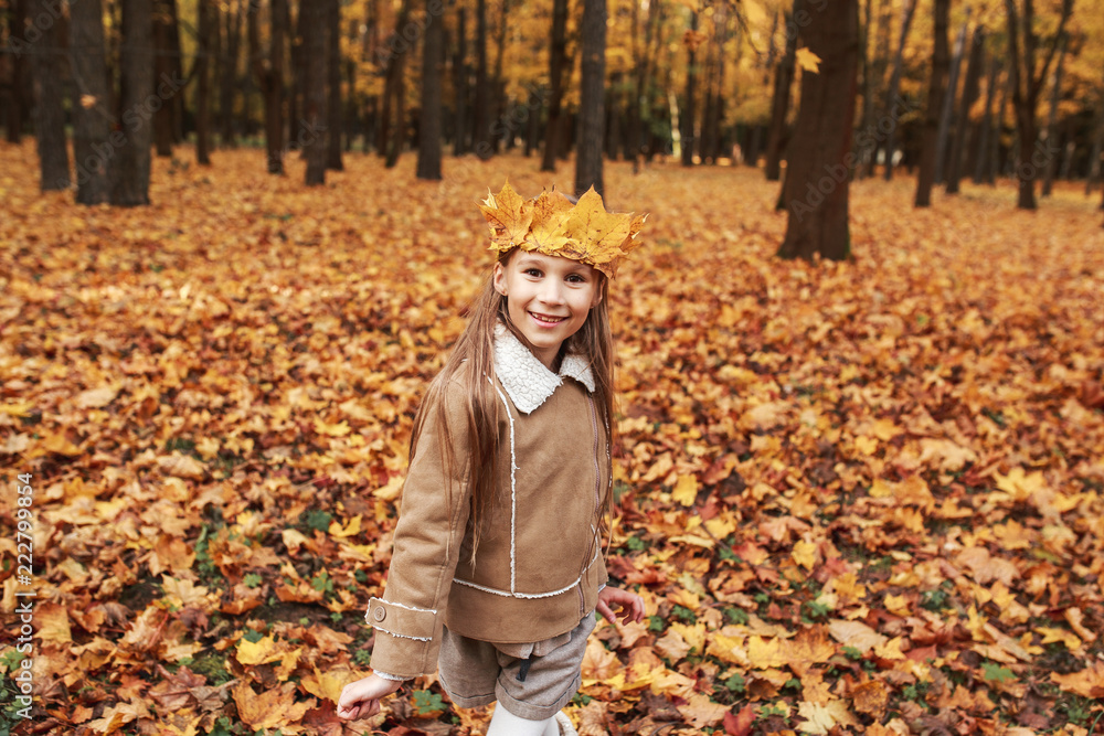 Little girl playing with autumn leaves in the park Little girl playing with autumn leaves in the park
