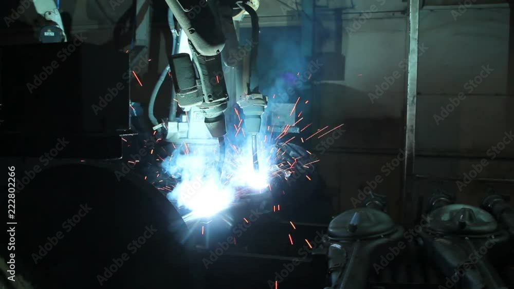 Welding robots movement in a car factory, automotive parts industry Welding robots movement in a car factory, automotive parts industry