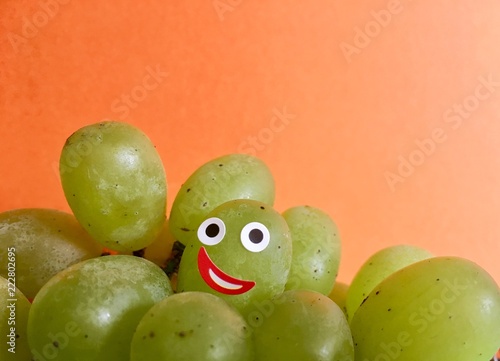 Smiling face on a grape