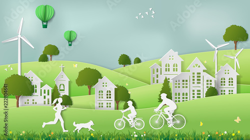 Paper folding art origami style vector illustration. Green sustainable energy ecology development concept Father & son riding bicycle, mother & dog jogging in village parks which full of wind turbine.