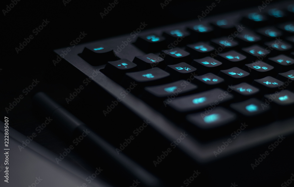 keyboard with blue backlight on work table. button light keyboard with blue backlight on work table. button light