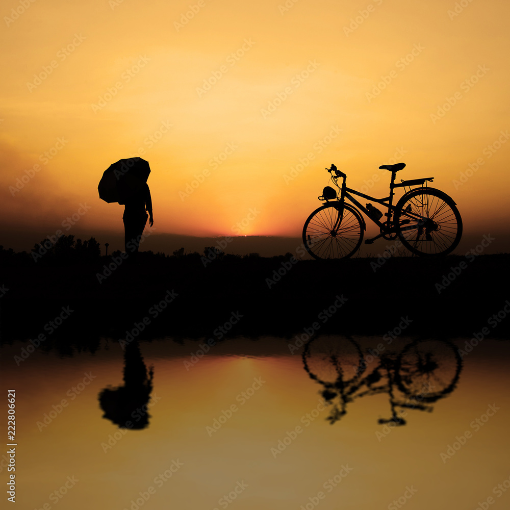 silhouette of a person riding a bike