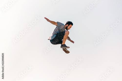 Fotografie Young parkour man jumping in skatepark