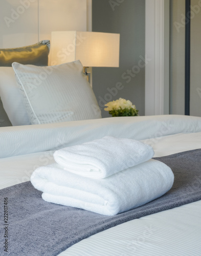 Clean towel on bed in modern interior bedroom