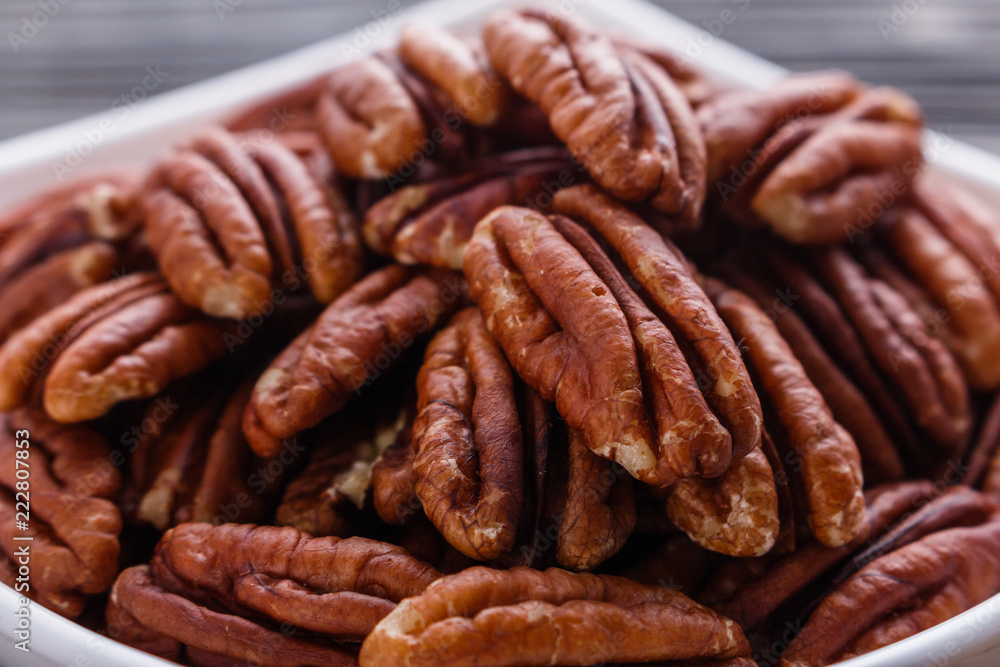 delicious pecan nuts on a rustic wooden background delicious pecan nuts on a rustic wooden background