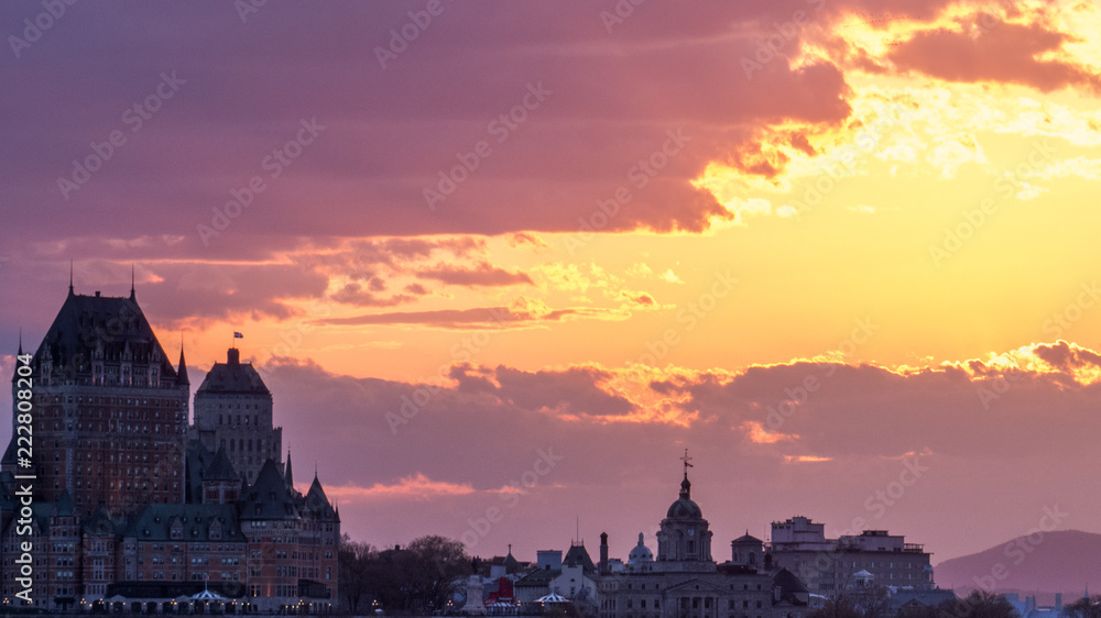 Bright sunset with light rays over Quebec City, Canada.